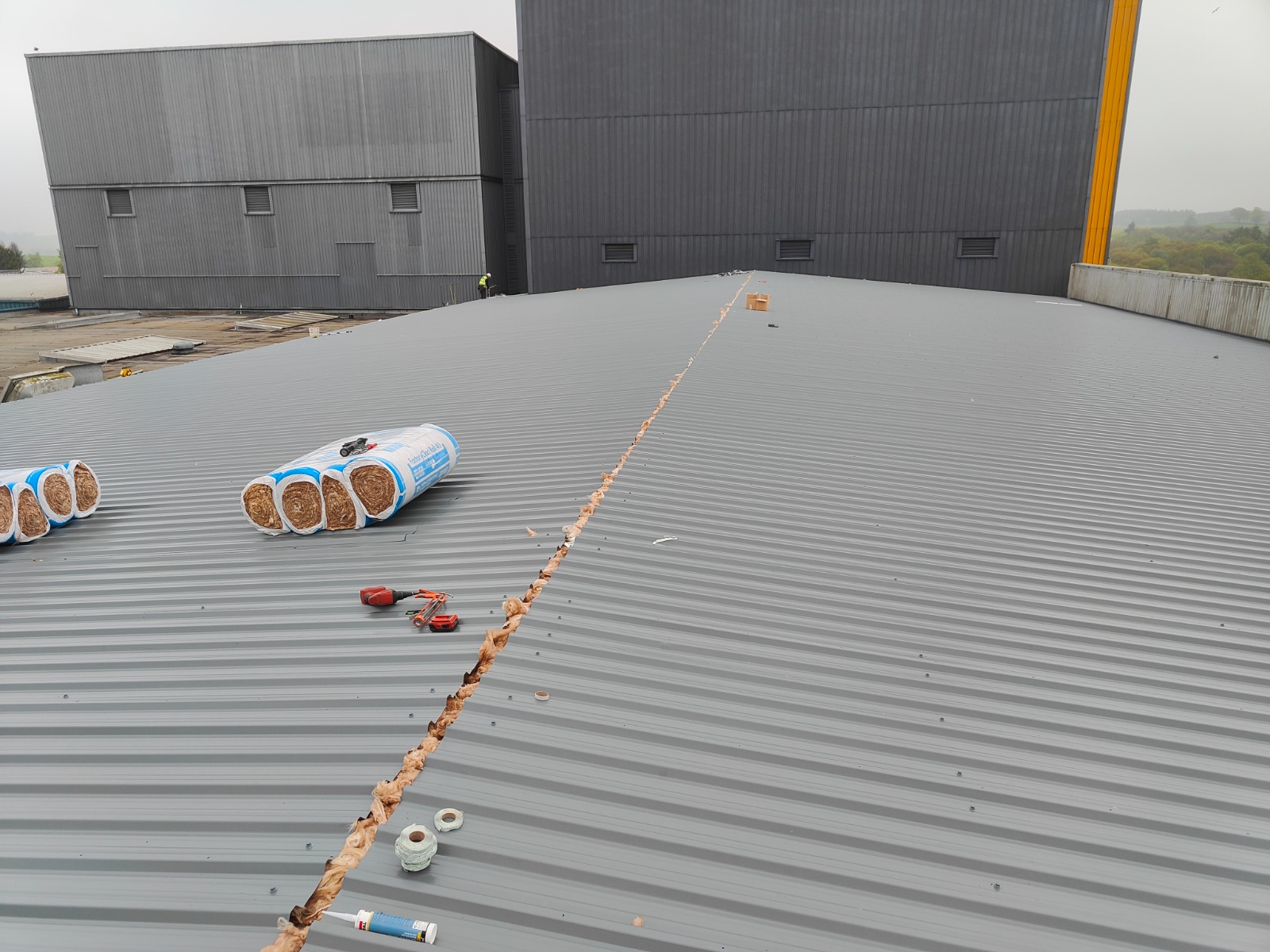 Large grey metal industrial roof installation