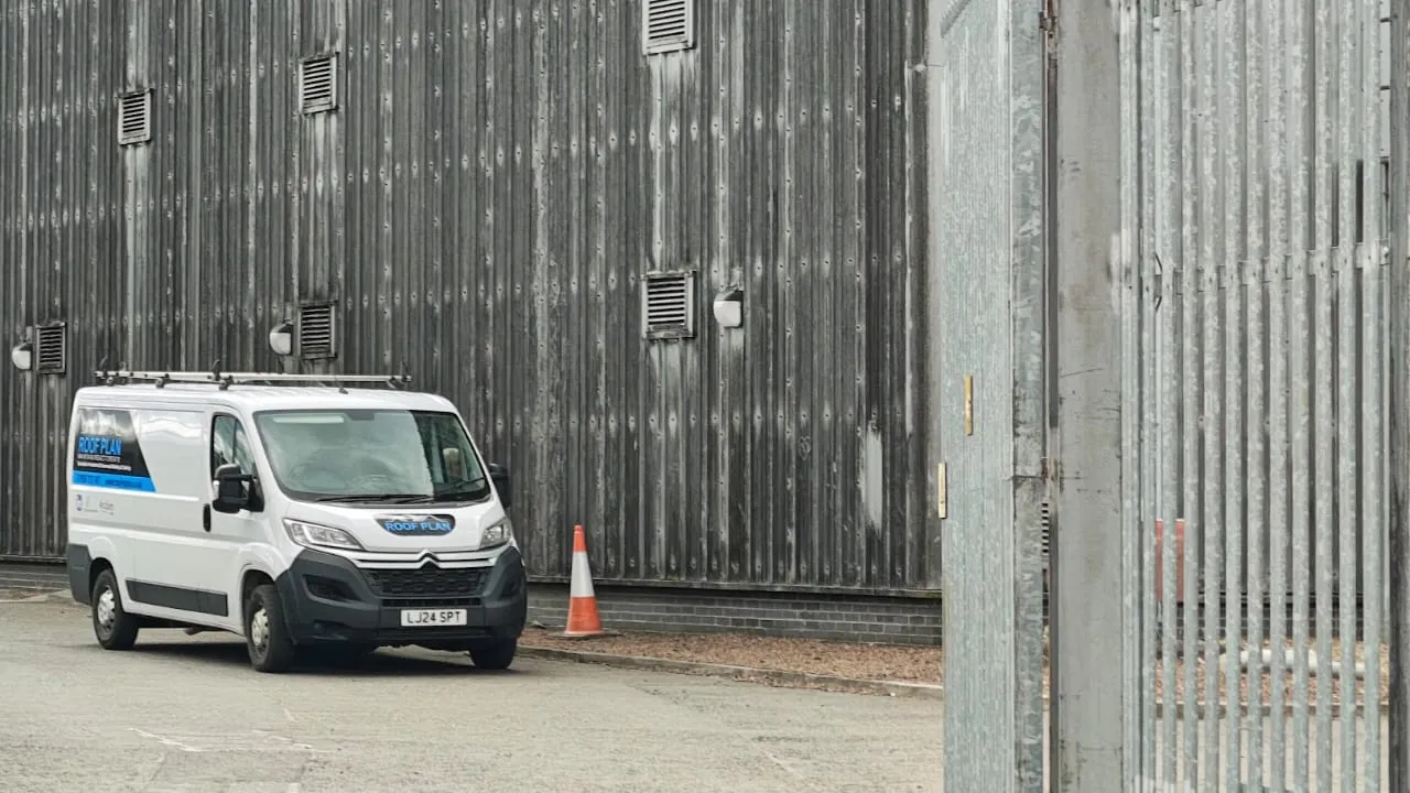 Roof Plan van outside a grey industrial building