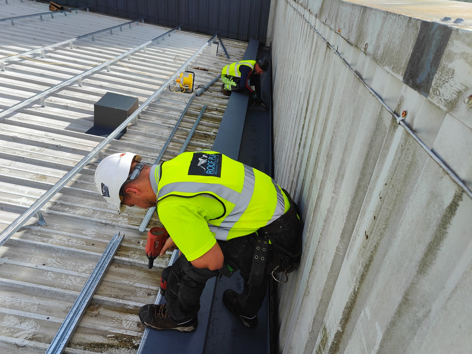 Roofer carrying out maintenance work on a roof